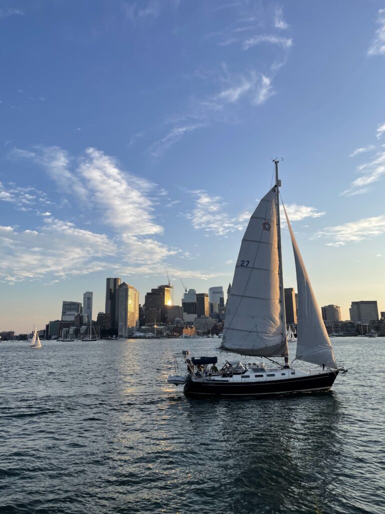 The Boston Harbor Summer with sail boats and Boston skyline