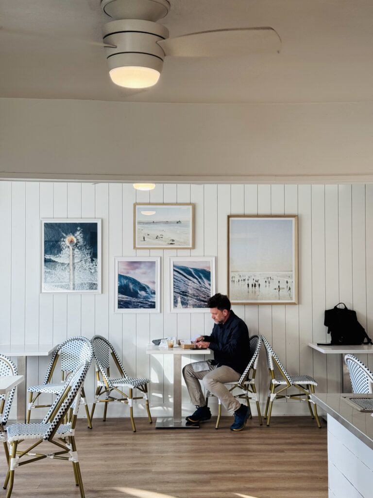 Jave Earth Coffee Interior white walls with pictures