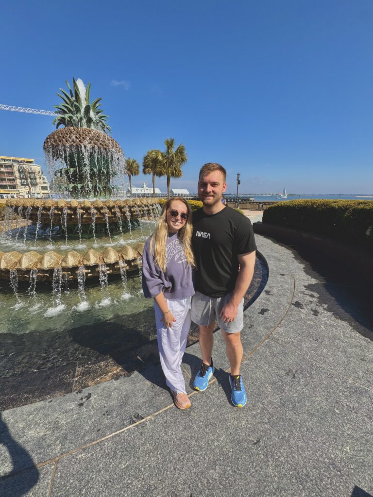 Couple in front of the pineapple fountain in Charleston