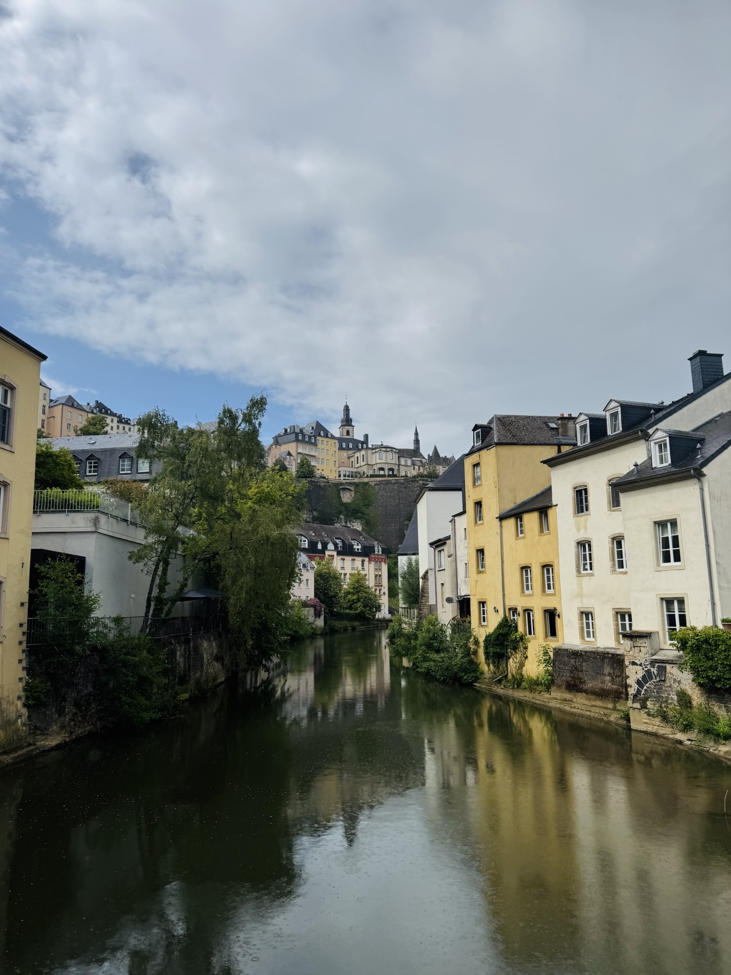 River in Luxembourg surrounded by buildings and greenery.