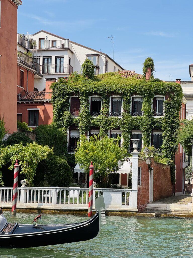 Building along a canal in Venice that is covered in ivy