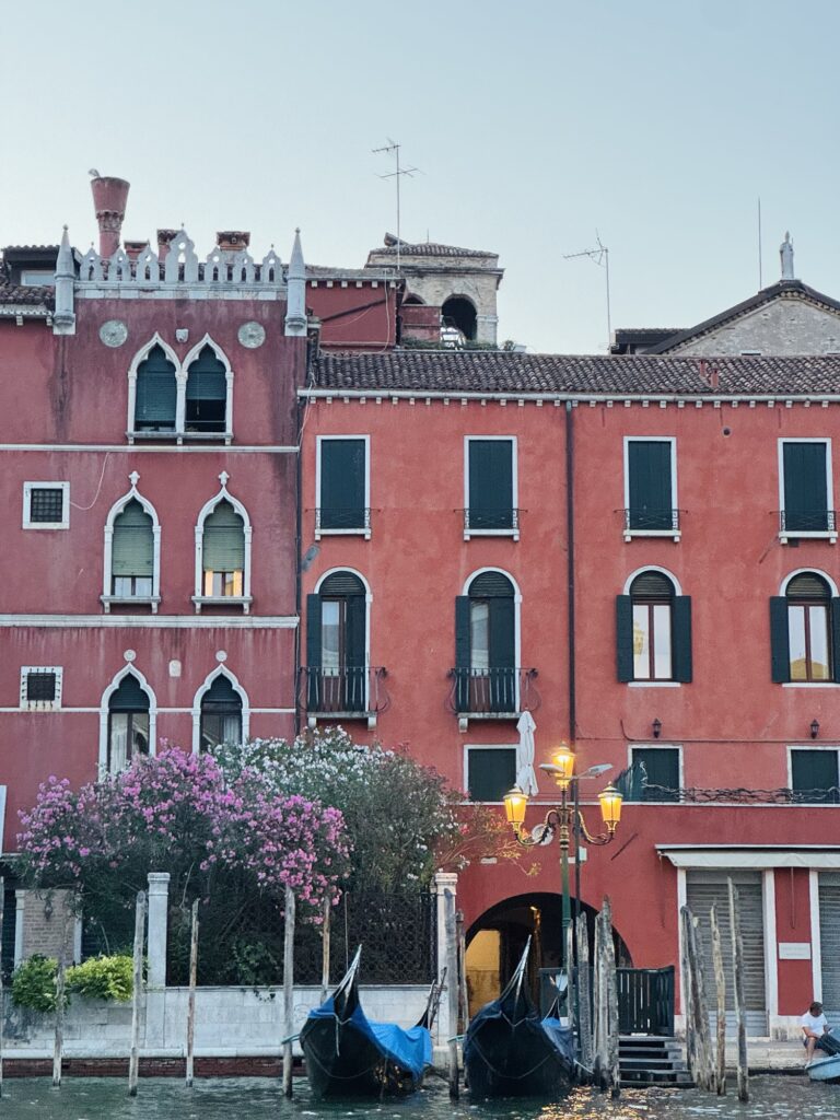 Exterior of red buildings on canal in Venice
