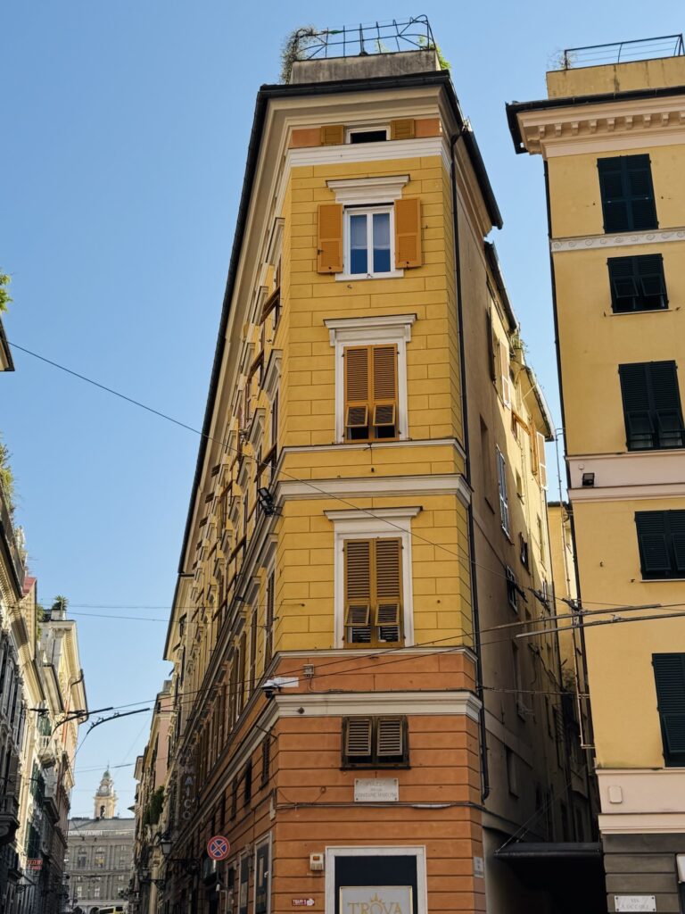 Yellow buildings with small alleys in Genoa Italy